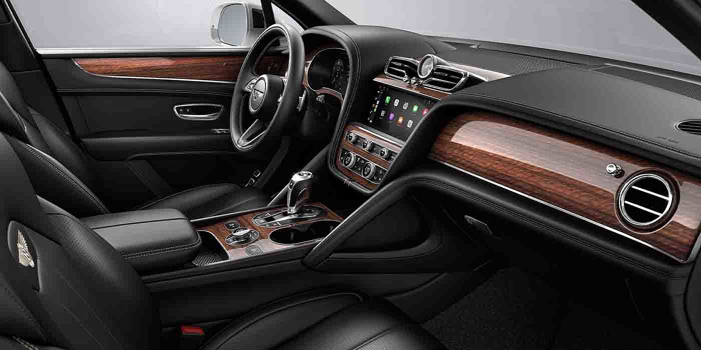 Bentley Kunming Bentley Bentayga EWB interior with a Crown Cut Walnut veneer, view from the passenger seat over looking the driver's seat.